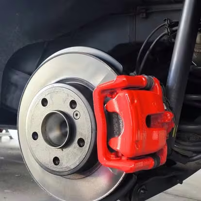 A mesma pinça Brembo pintada de vermelho, montada na jante